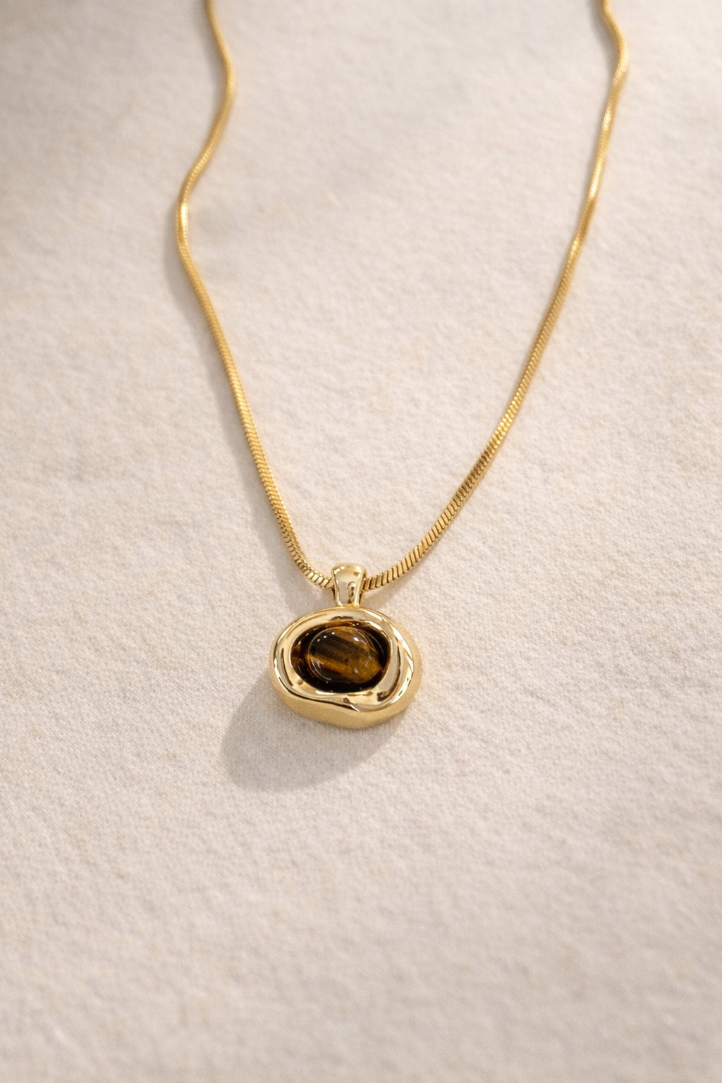 Natural tiger’s eye gemstone necklace in organic gold bezel