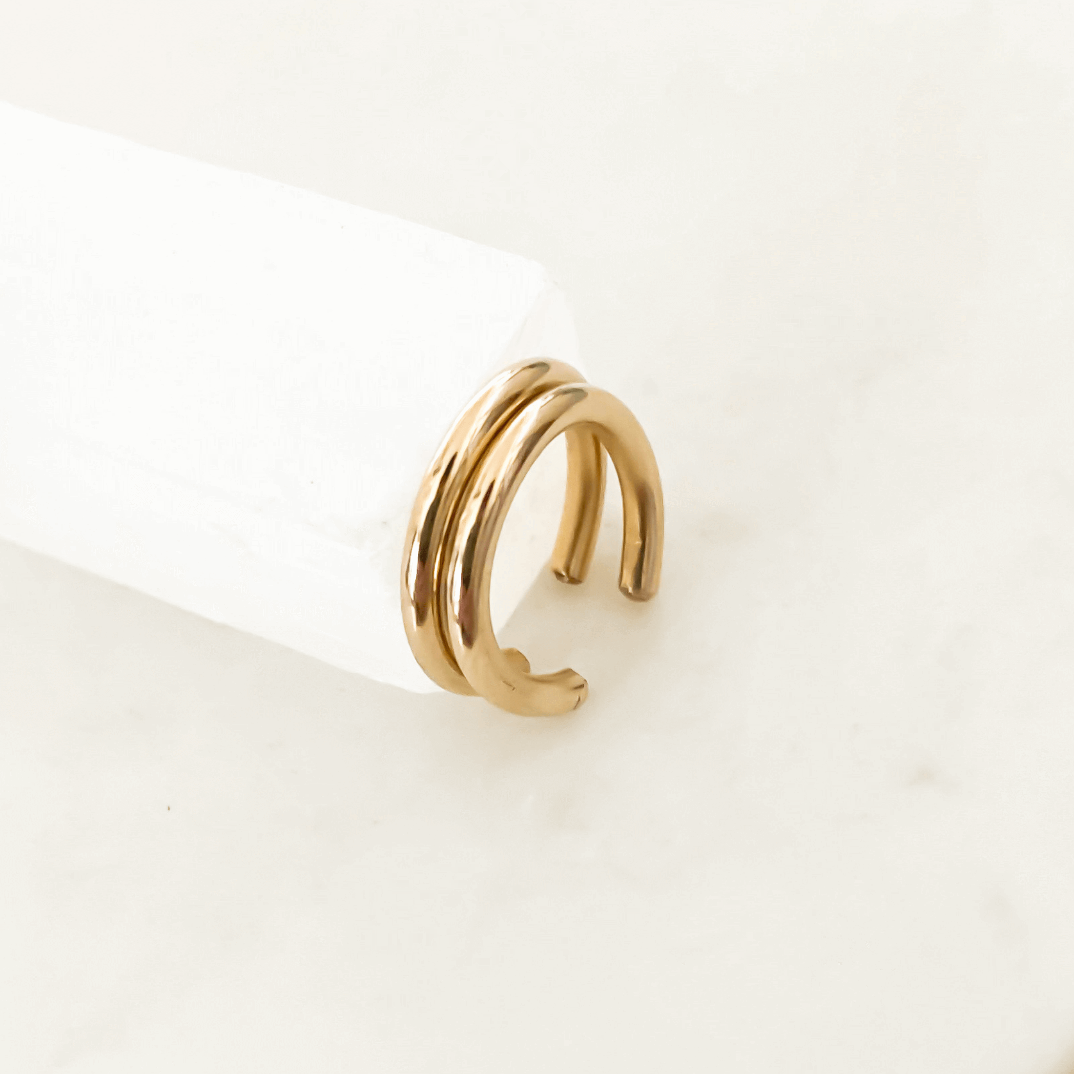 Everyday Ear Cuff, featuring a gold twisted design and requiring no piercing, displayed on a white surface with a minimalistic background.