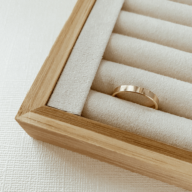 A simple, versatile 3 mm Everyday Gold Ring displayed in a wooden jewelry box with a beige fabric interior.