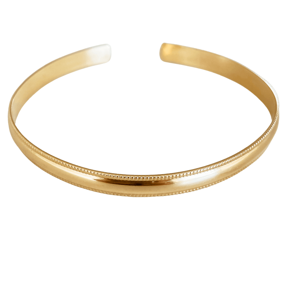 A minimalist yet striking piece from our essentials collection, the Bold Cuff Bracelet in gold features a smooth finish with a distinctive ridged edge design.